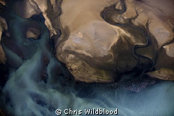 Aerial view from about 2000ft of the tide draining into t... by Chris Wildblood 